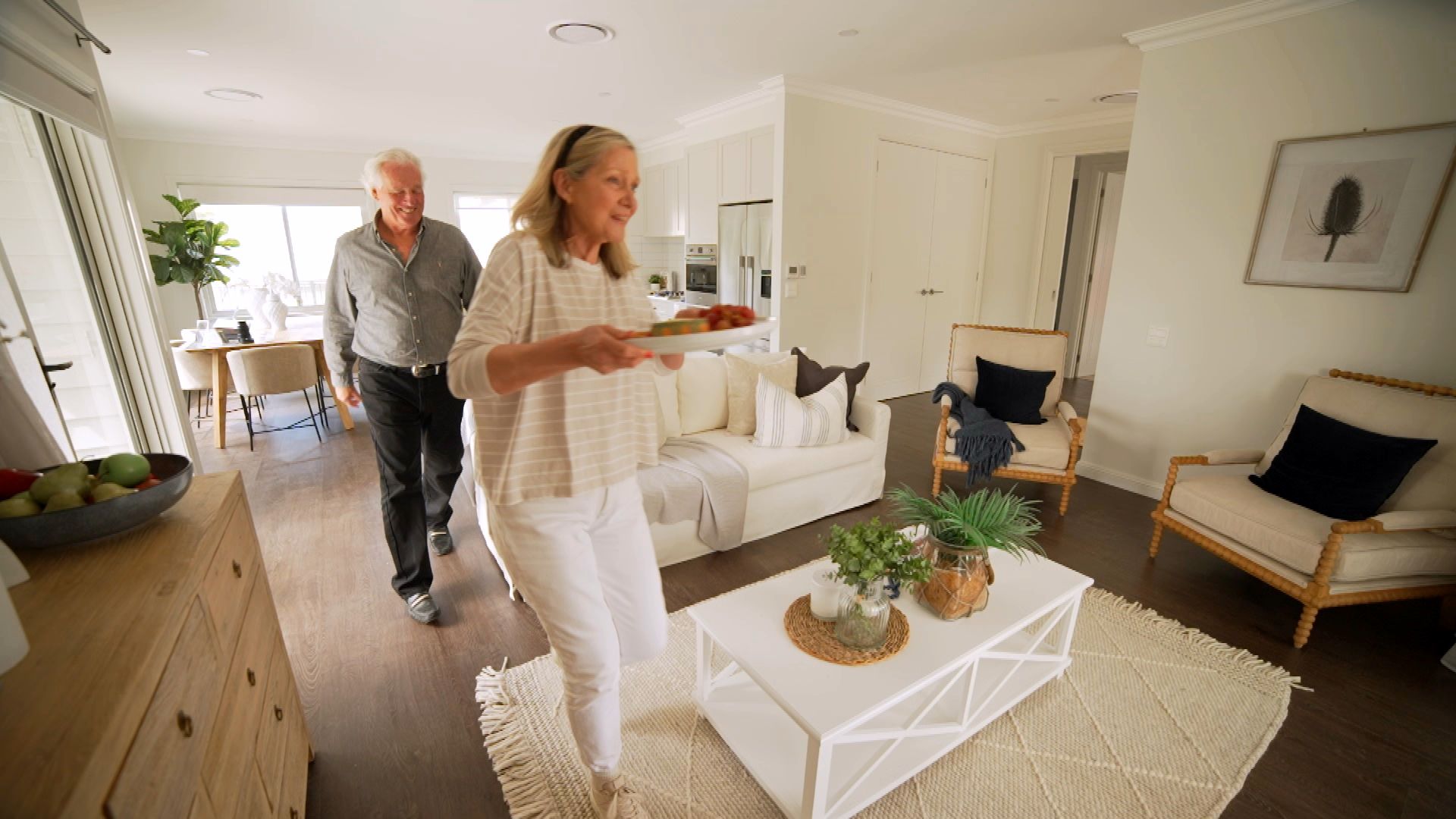 Visitors exploring a bright, open-plan living room in an architect-designed home at Woodside Bundanoon.